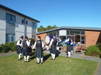 In the courtyard, in the Sunshine, playing well known Scottish tunes.